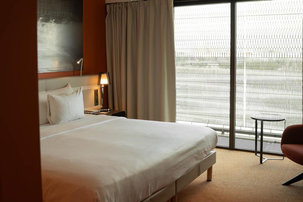 Un ou plusieurs lits dans un hébergement de l'établissement Radisson Blu Hotel Bordeaux