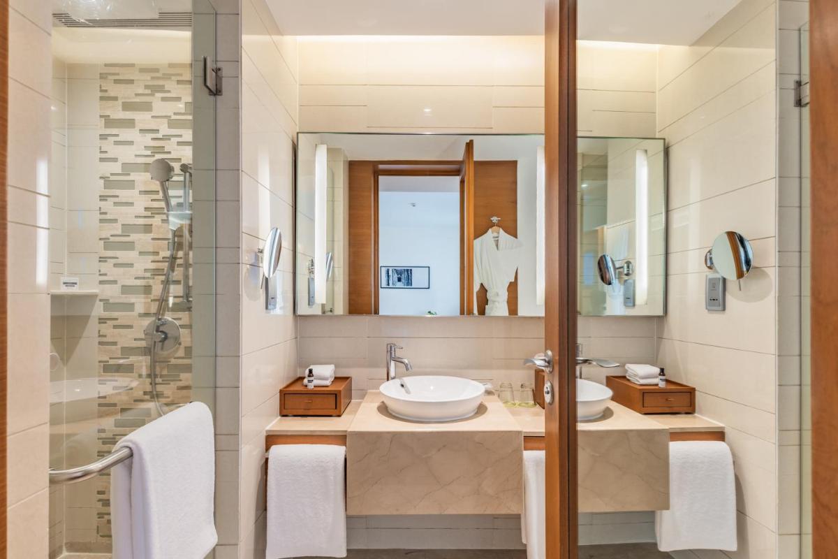a bathroom with two sinks and a shower at Hyatt Pune in Pune