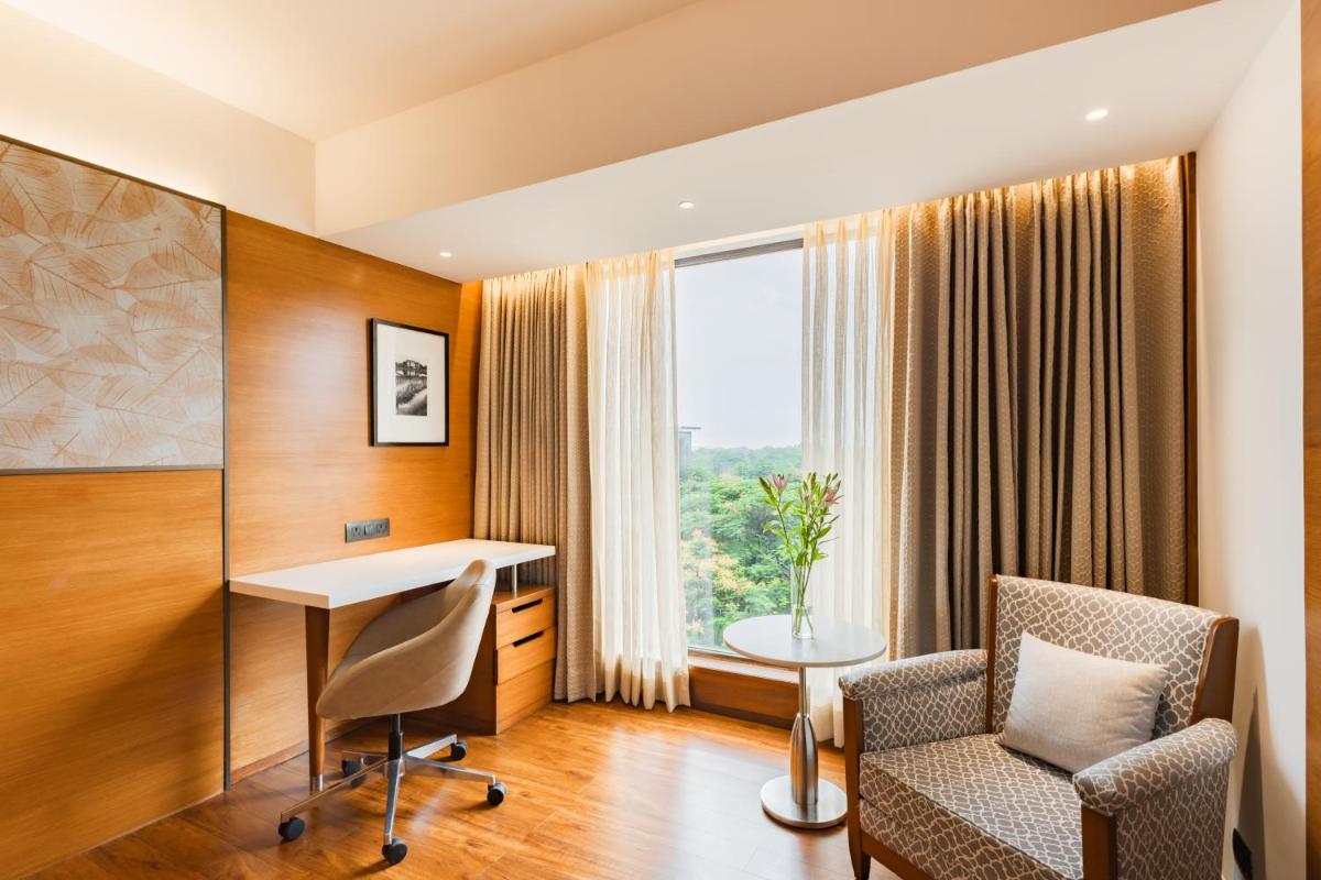 an office with a desk and a chair and a window at Hyatt Pune in Pune