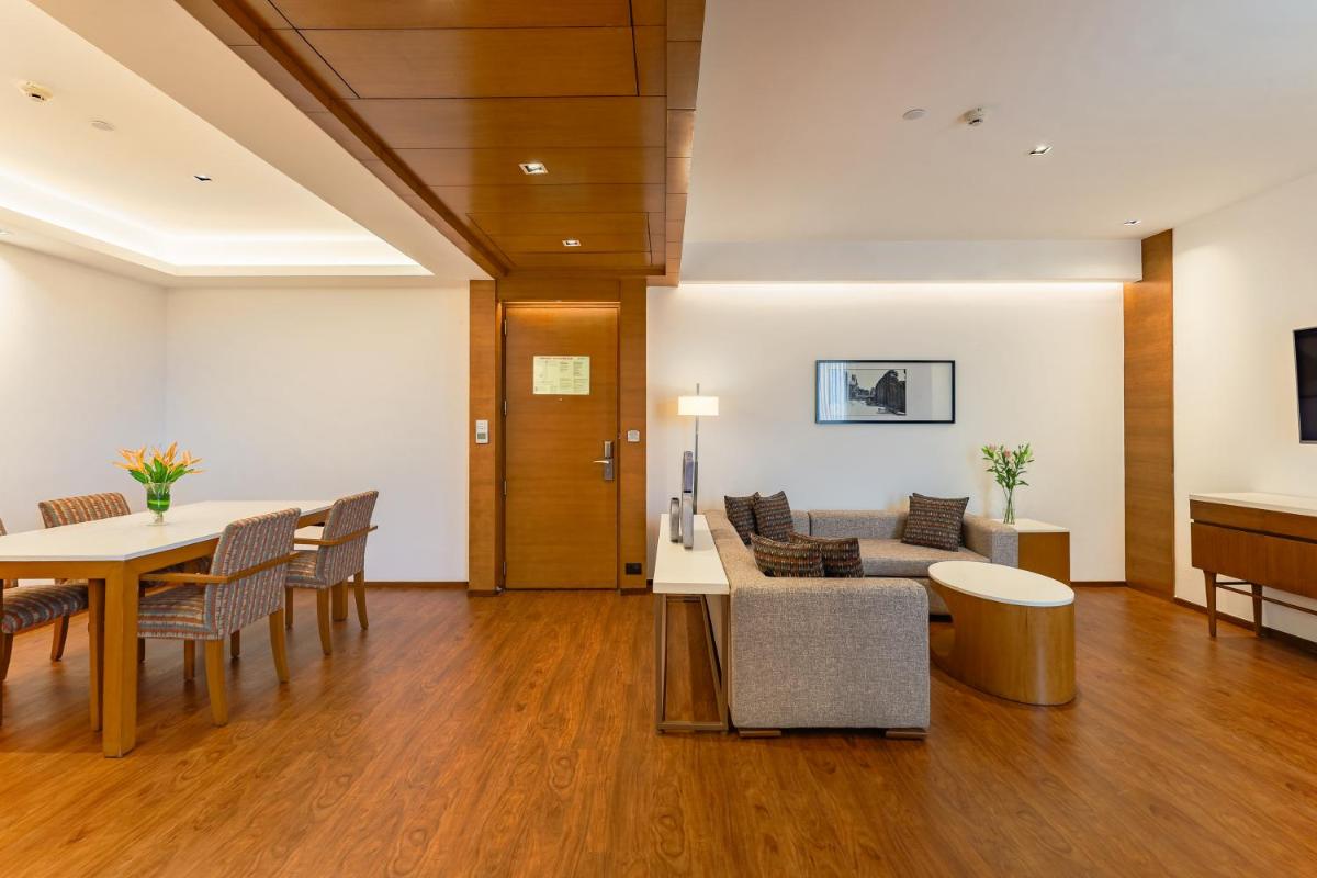 a living room with a couch and a table and chairs at Hyatt Pune in Pune