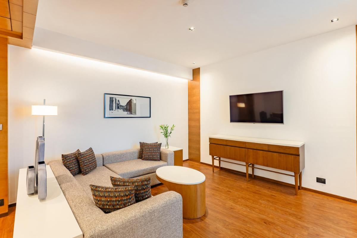 a living room with a couch and a piano at Hyatt Pune in Pune