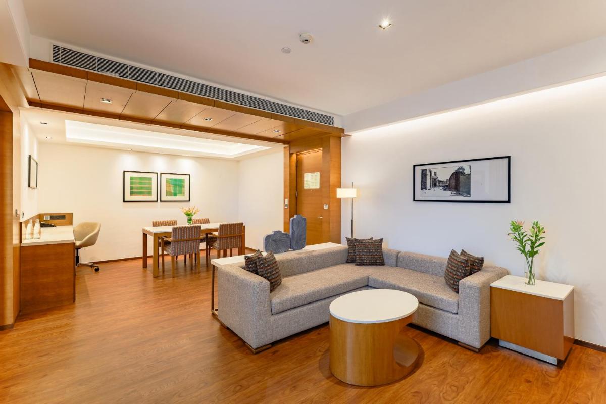 a living room with a couch and a table at Hyatt Pune in Pune
