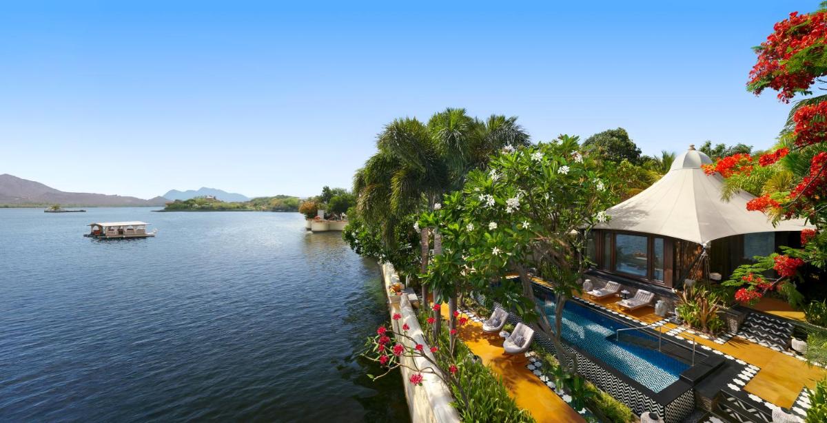 a view of a river with a building next to the water at The Leela Palace Udaipur in Udaipur
