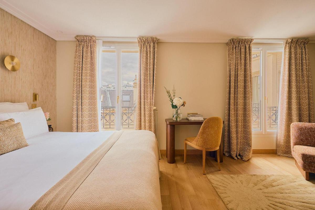 Un ou plusieurs lits dans un hébergement de l'établissement Hôtel Madison