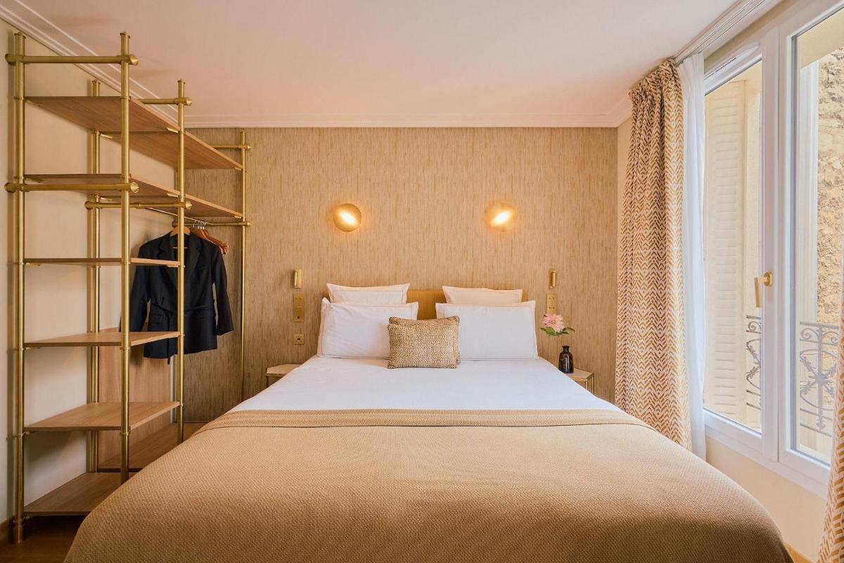 Un ou plusieurs lits dans un hébergement de l'établissement Hôtel Madison