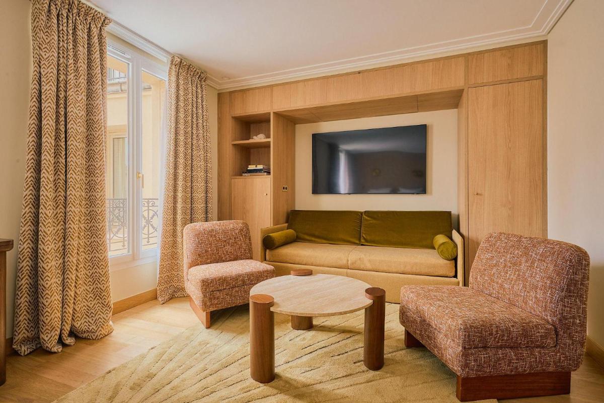 Coin salon dans l'établissement Hôtel Madison