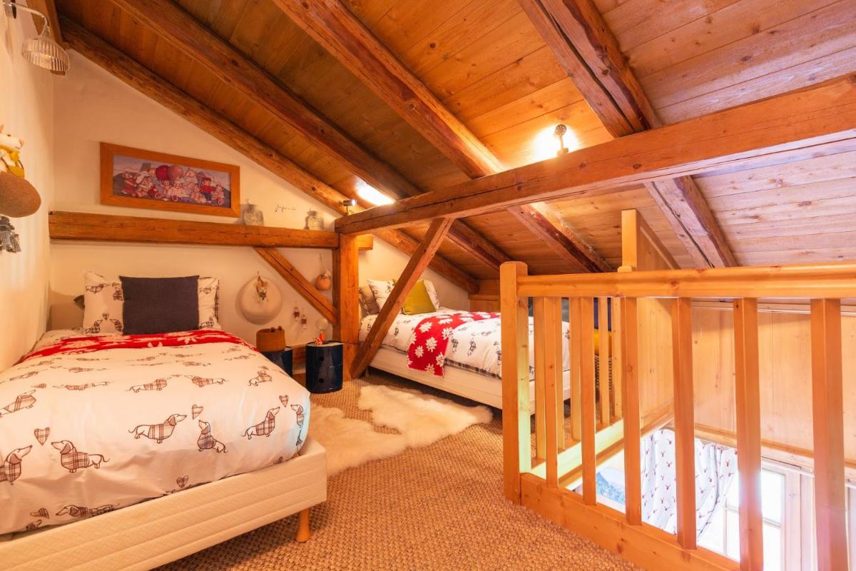 Un ou plusieurs lits dans un hébergement de l'établissement Magic Megève Bois