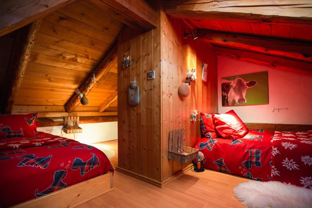 Un ou plusieurs lits dans un hébergement de l'établissement Magic Megève Bois