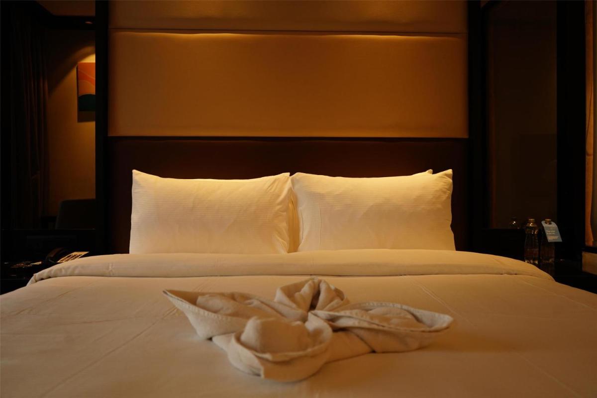 a white towel on a bed in a hotel room at Hilton Garden Inn Pune Hinjawadi in Pune