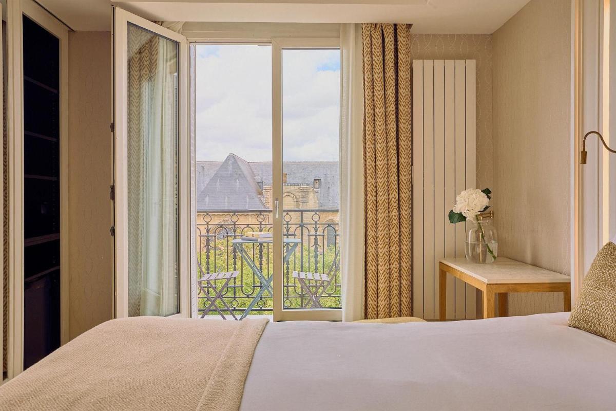 Un ou plusieurs lits dans un hébergement de l'établissement Hôtel Madison