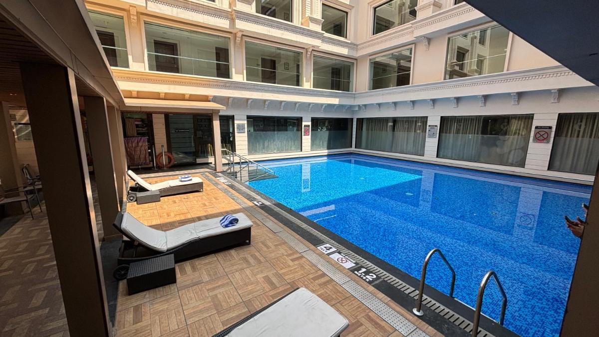 a large swimming pool in the middle of a building at Fortune JP Palace, Mysore - Member ITC Hotels' Group in Mysore