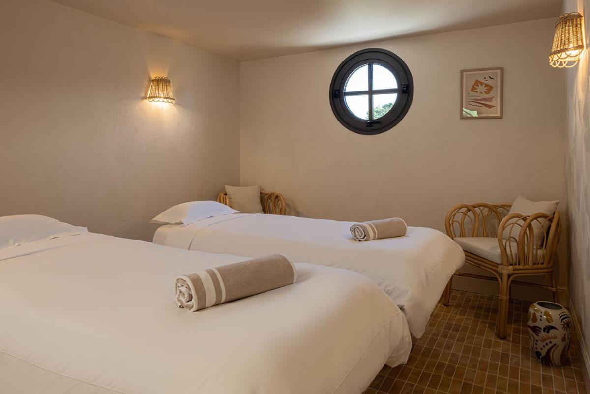 Un ou plusieurs lits dans un hébergement de l'établissement Hôtel Maison Chiberta