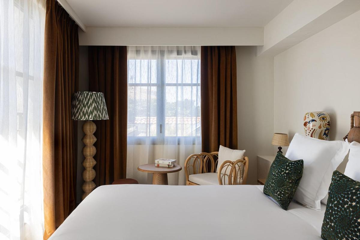 Un ou plusieurs lits dans un hébergement de l'établissement Hôtel Maison Chiberta