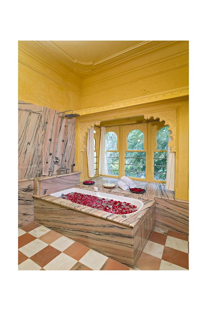 a bedroom with a large bed in a room at Chunda Palace in Udaipur