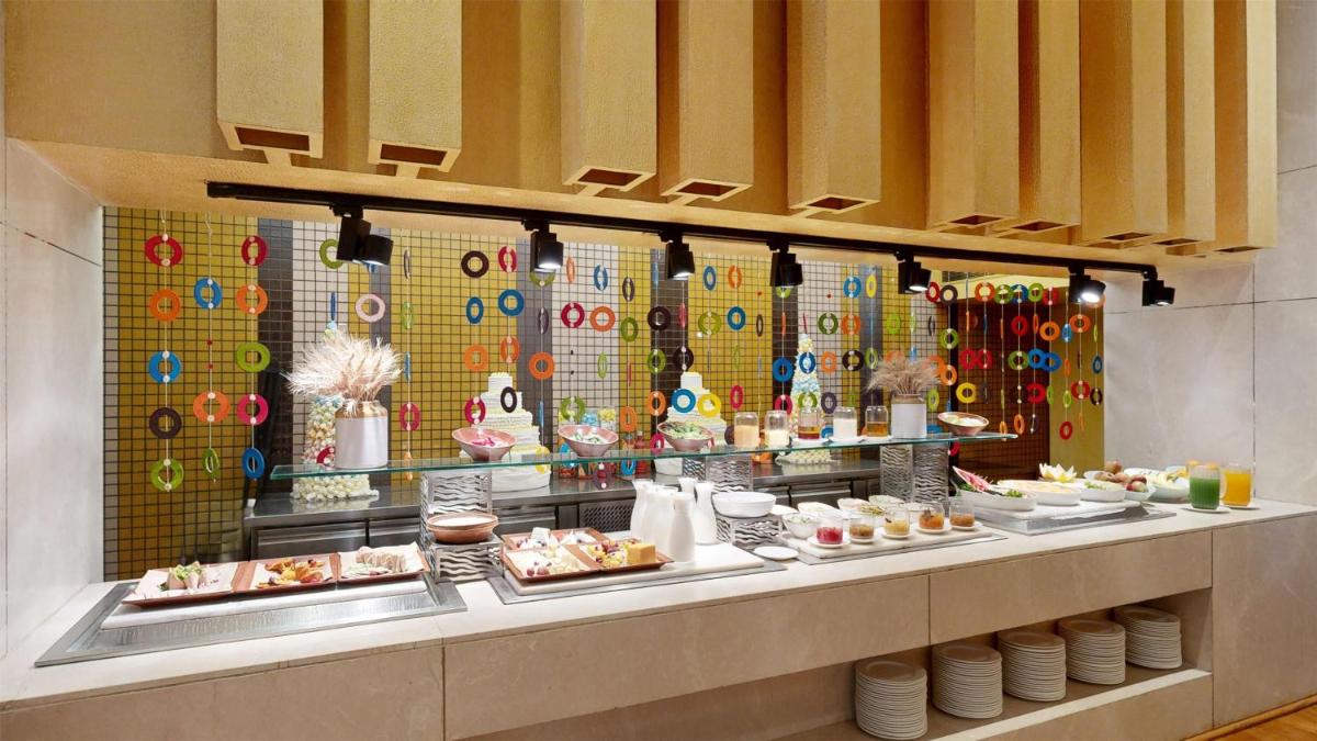 a buffet line with plates of food on display at Radisson Blu Hotel Amritsar in Amritsar