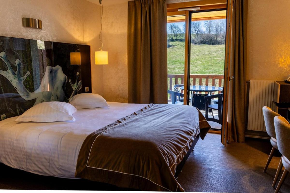 Un ou plusieurs lits dans un hébergement de l'établissement Hôtel L'Etang du Moulin By Céline