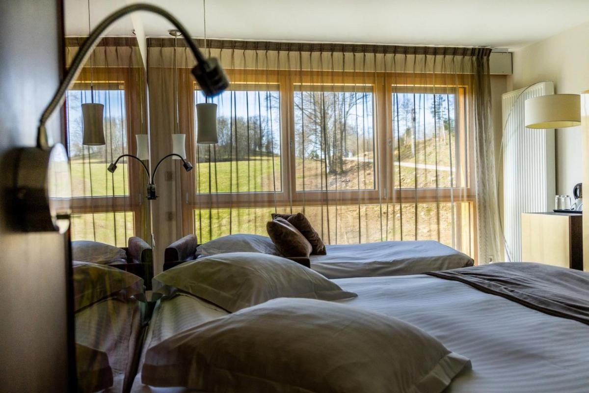 Un ou plusieurs lits dans un hébergement de l'établissement Hôtel L'Etang du Moulin By Céline