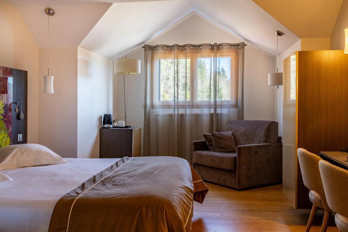 Un ou plusieurs lits dans un hébergement de l'établissement Hôtel L'Etang du Moulin By Céline