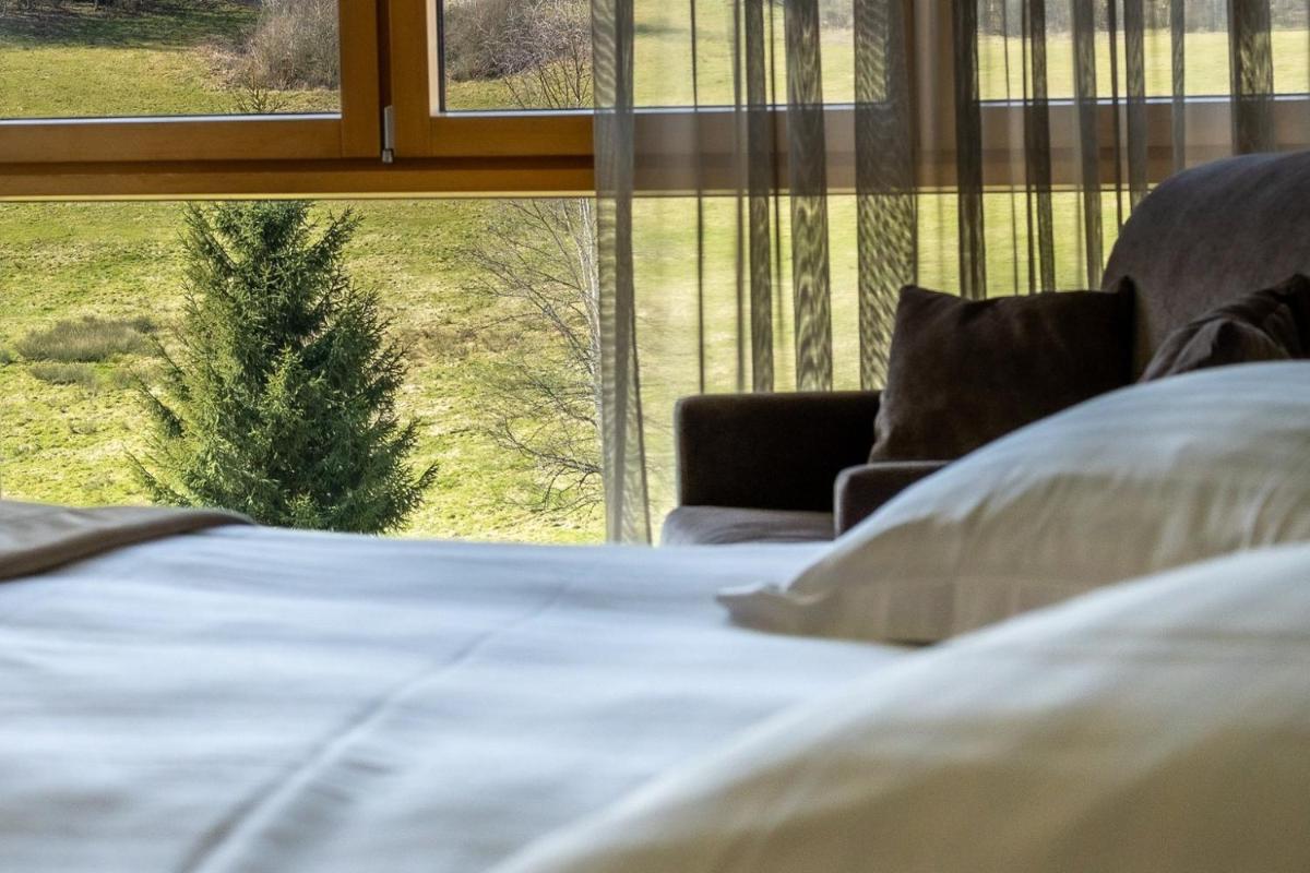 Un ou plusieurs lits dans un hébergement de l'établissement Hôtel L'Etang du Moulin By Céline