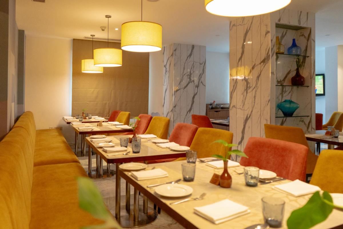 a dining room with long tables and chairs at Radisson Blu Kochi in Cochin