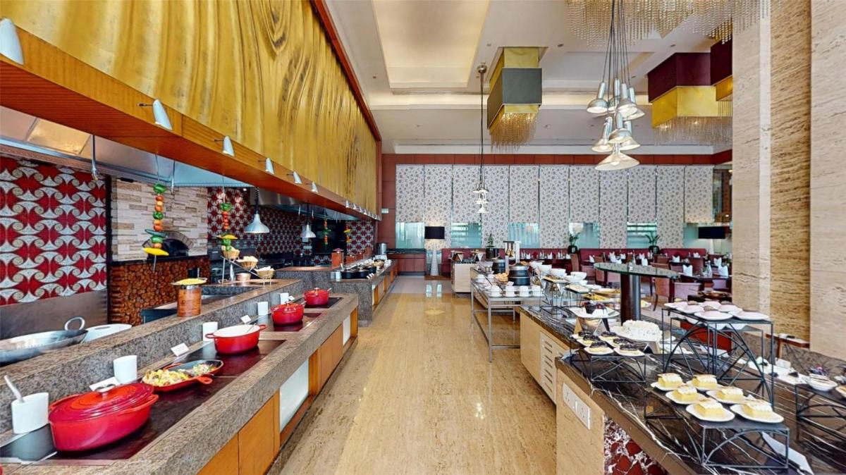 a restaurant with a buffet line with food on display at Radisson Blu Hotel, Nagpur in Nagpur