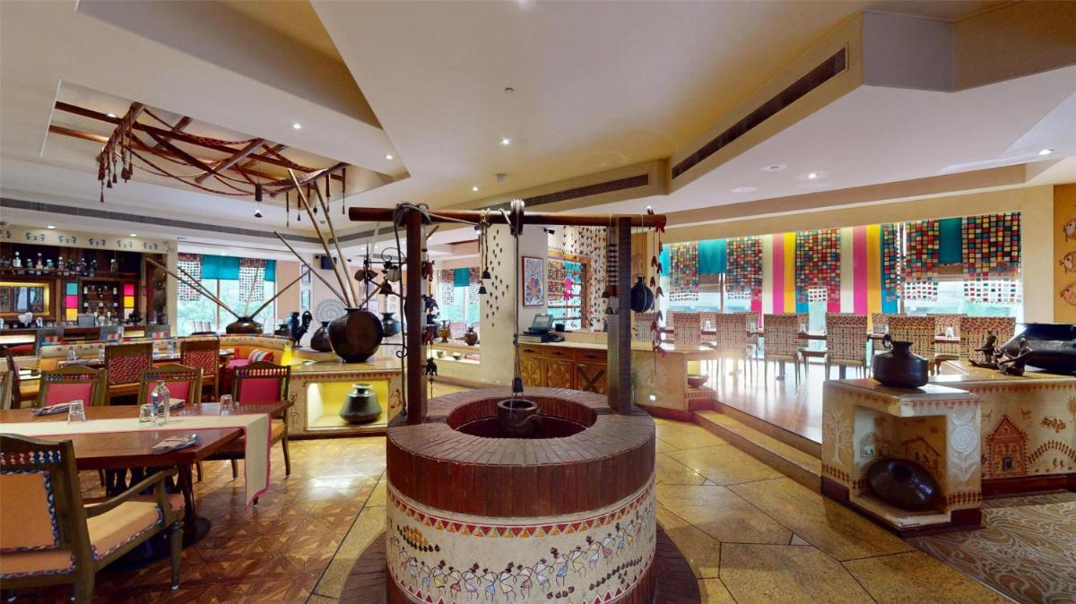 a restaurant with a large barrel in the middle of a room at Radisson Blu Hotel, Nagpur in Nagpur