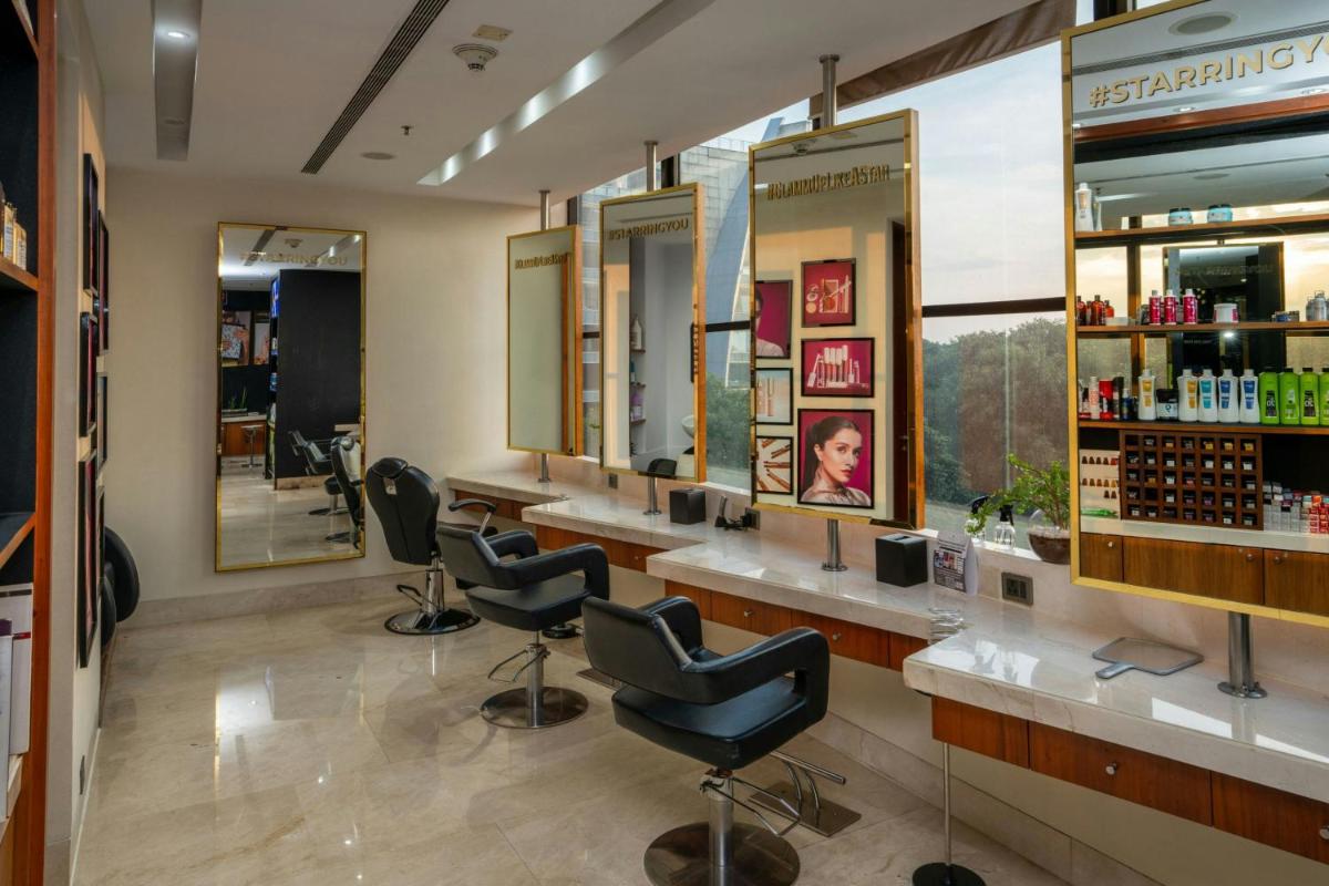 a barber shop with chairs and mirrors at JW Marriott Hotel Bengaluru in Bengaluru