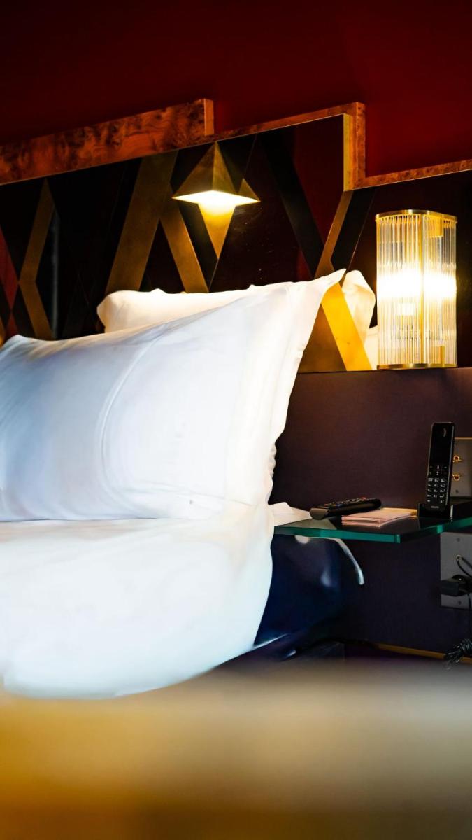 Un ou plusieurs lits dans un hébergement de l'établissement Hôtel Saint-Marc