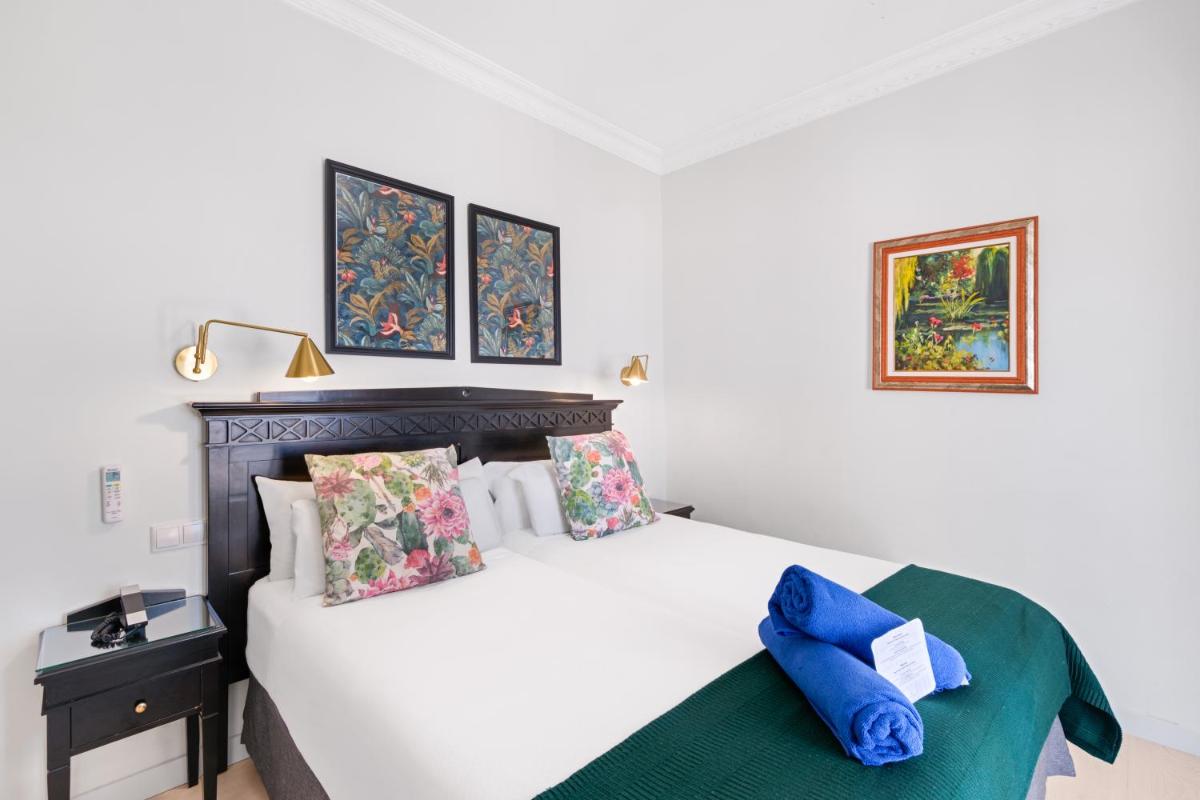 Cama o camas de una habitación en Hotel Ciutat Jardi