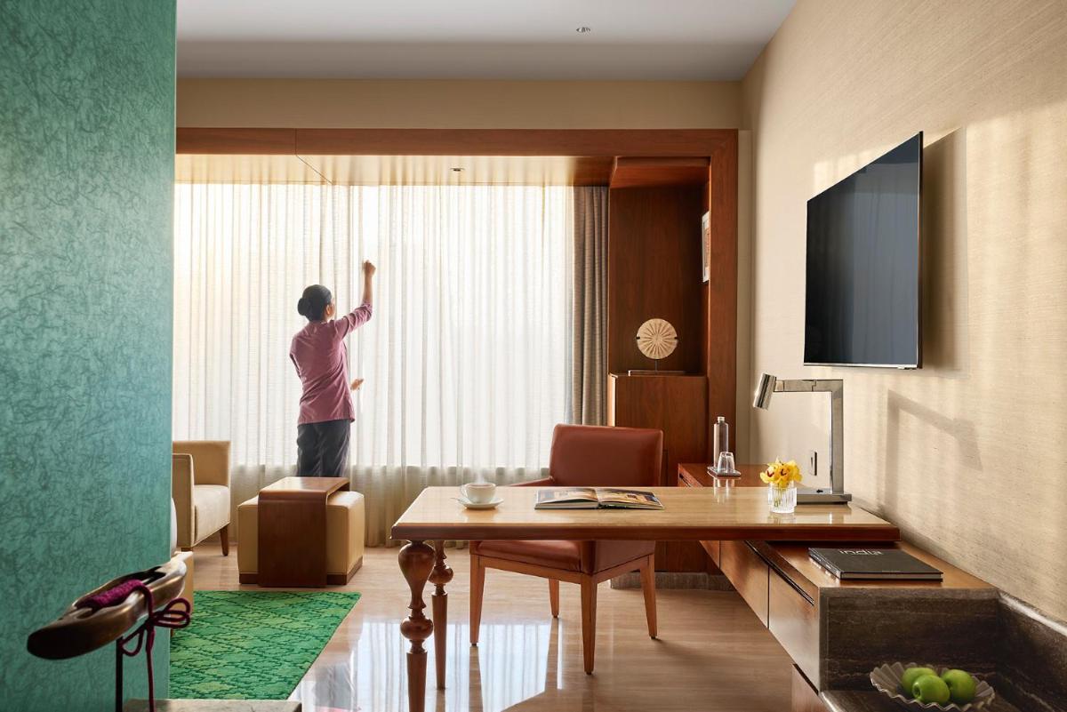 a man standing in a room looking out the window at Park Hyatt Chennai in Chennai