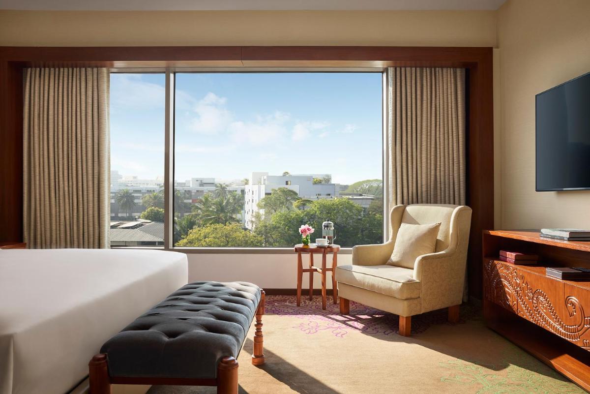 a hotel room with a bed and a large window at Park Hyatt Chennai in Chennai