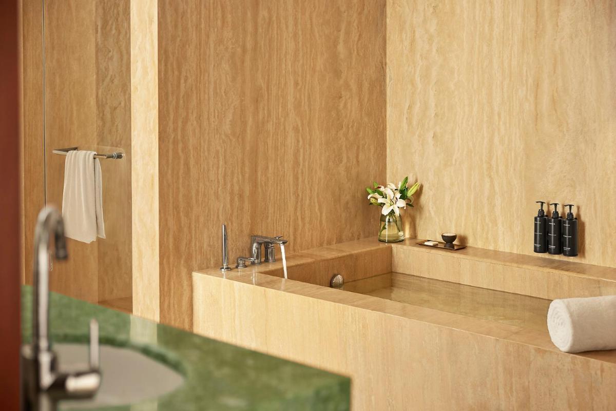 a bathroom with a sink and a vase of flowers at Park Hyatt Chennai in Chennai