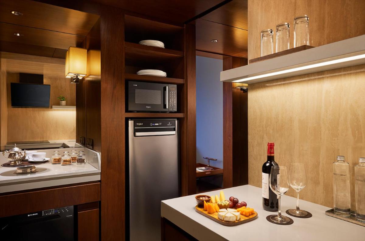 a kitchen with a refrigerator and a plate of fruit at Park Hyatt Chennai in Chennai