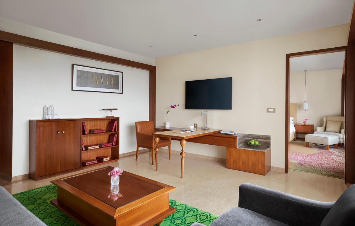 a living room with a desk and a tv at Park Hyatt Chennai in Chennai