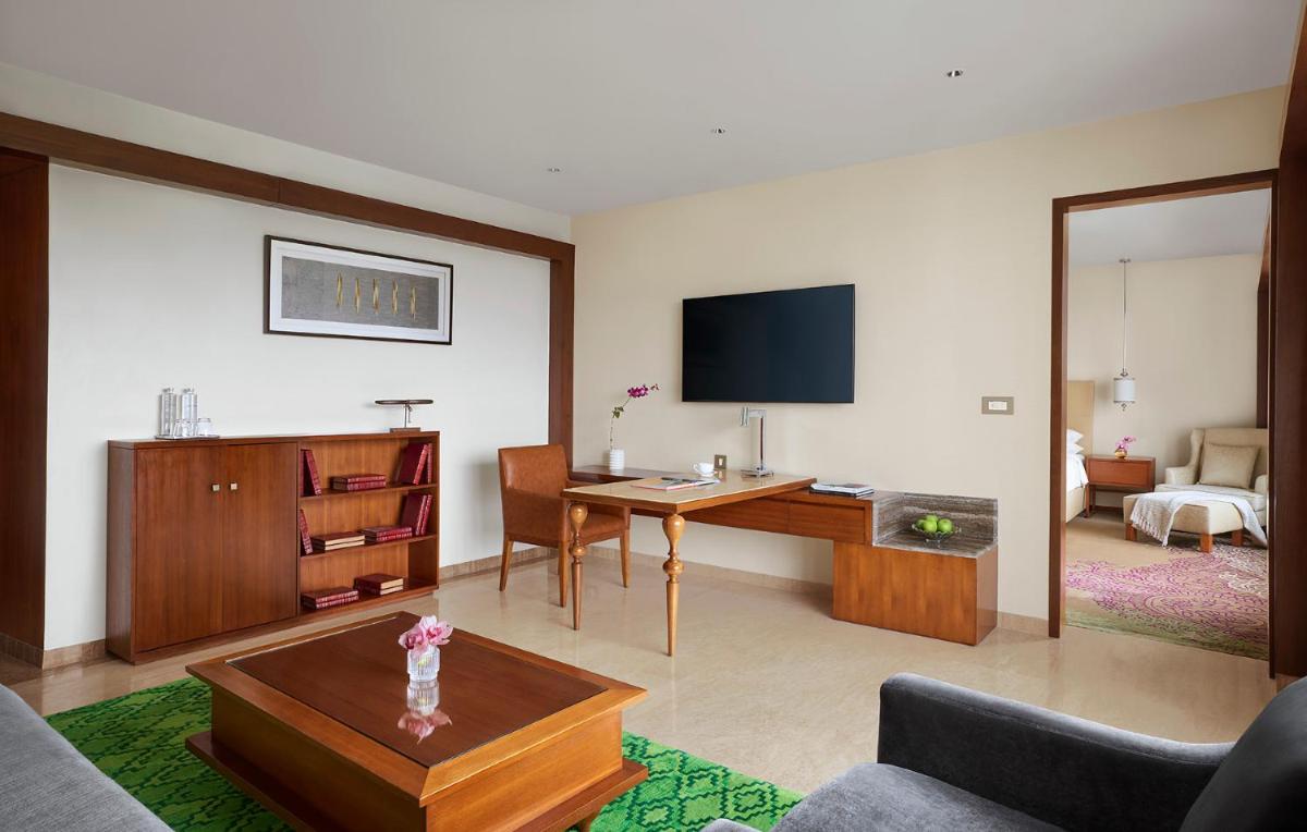 a living room with a desk and a tv at Park Hyatt Chennai in Chennai