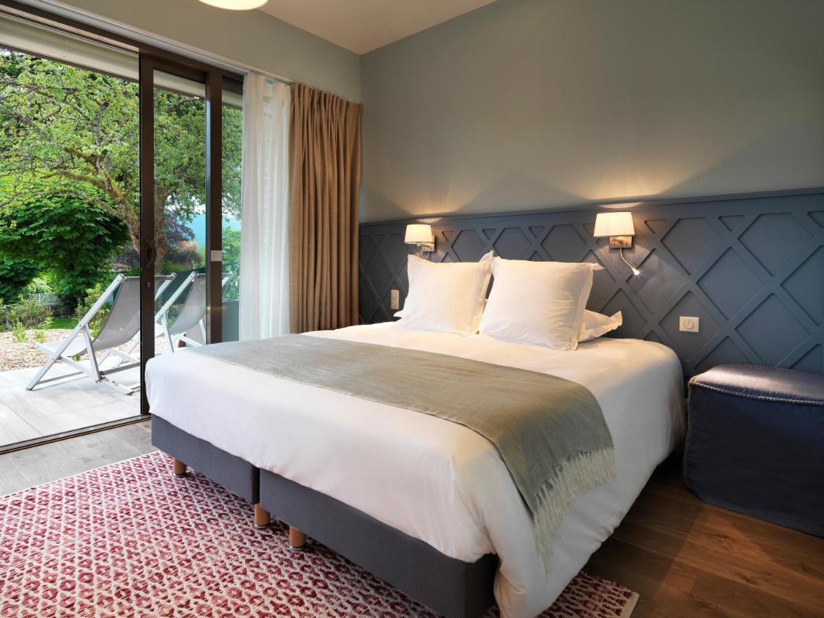 Un ou plusieurs lits dans un hébergement de l'établissement Hôtel Beau Site Talloires B SPA