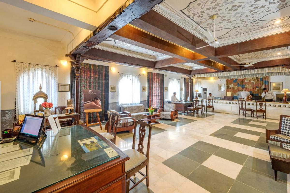 a large room with a lobby with tables and chairs at Neemrana Fort-Palace in Neemrana