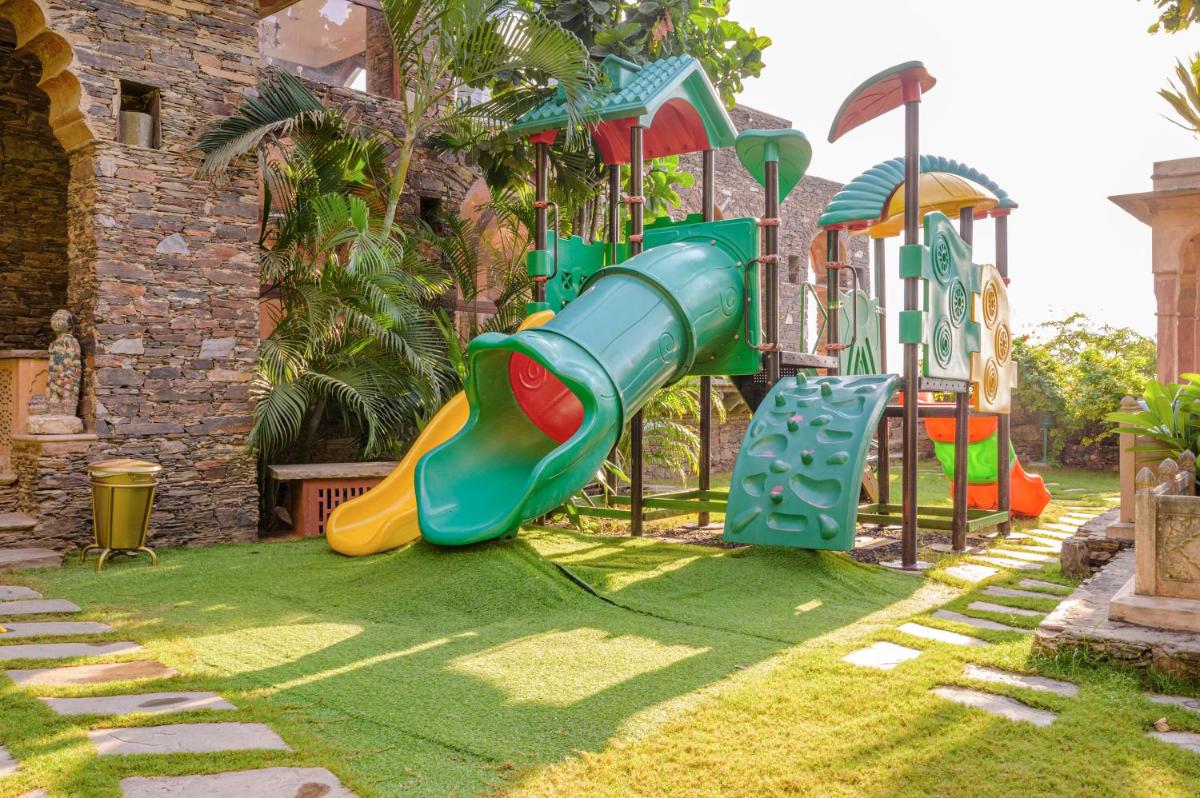 a playground with a slide in a yard at Neemrana Fort-Palace in Neemrana