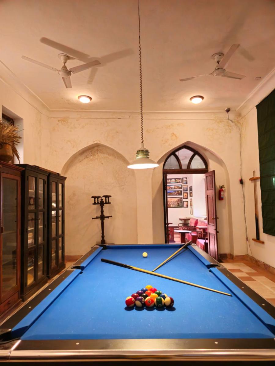 a pool table in the middle of a room at Neemrana Fort-Palace in Neemrana