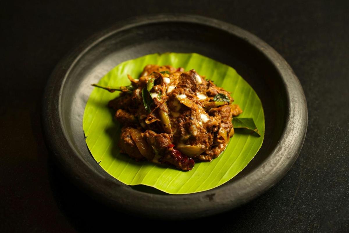 a plate of food in a bowl on a table at Kochi Marriott Hotel in Cochin