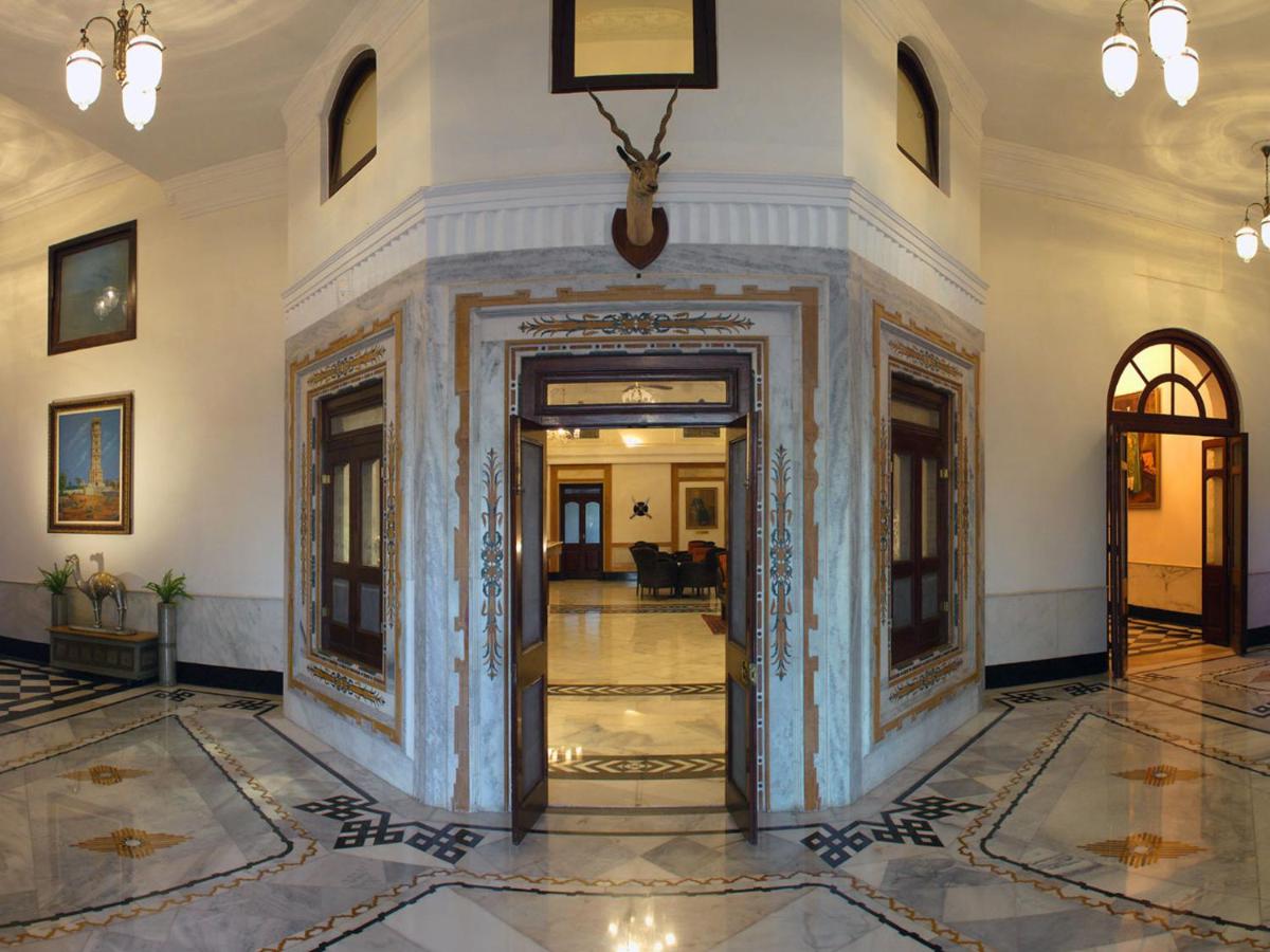 a hallway with a door in a building at The Lalit Laxmi Vilas Palace in Udaipur