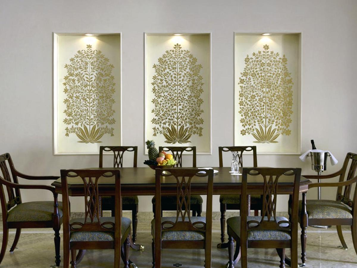 a dining room with a table and chairs at The Lalit Laxmi Vilas Palace in Udaipur
