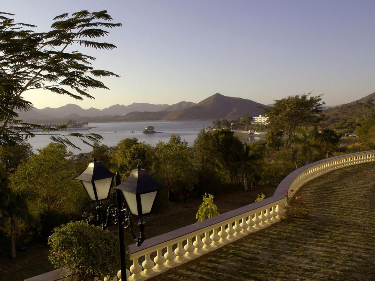 a street light next to a wall with a view of a river at The Lalit Laxmi Vilas Palace in Udaipur