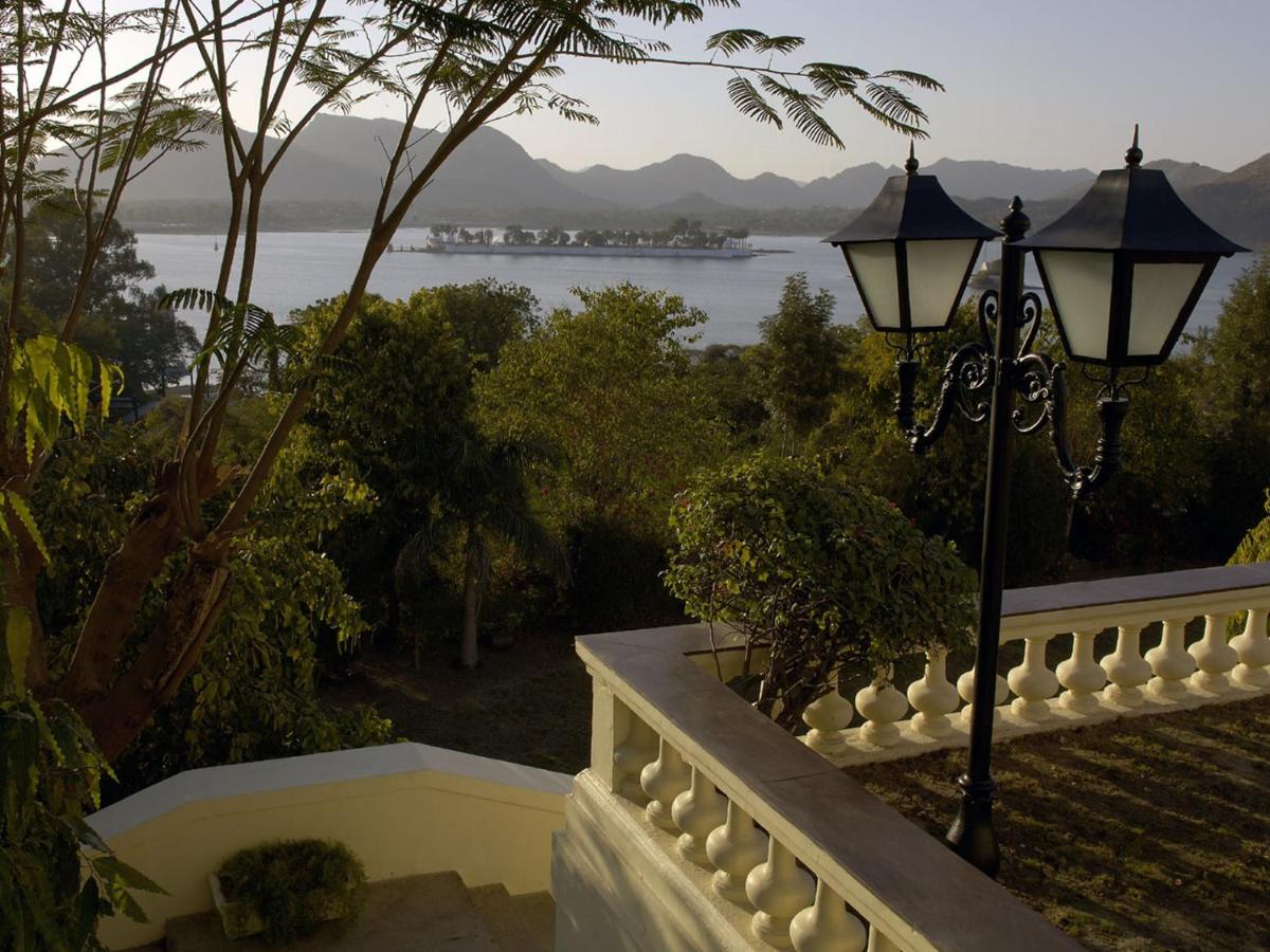 a street light on a balcony with a view of the water at The Lalit Laxmi Vilas Palace in Udaipur