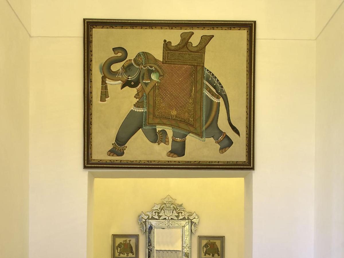 a picture of an elephant with a crown on a wall at The Lalit Laxmi Vilas Palace in Udaipur