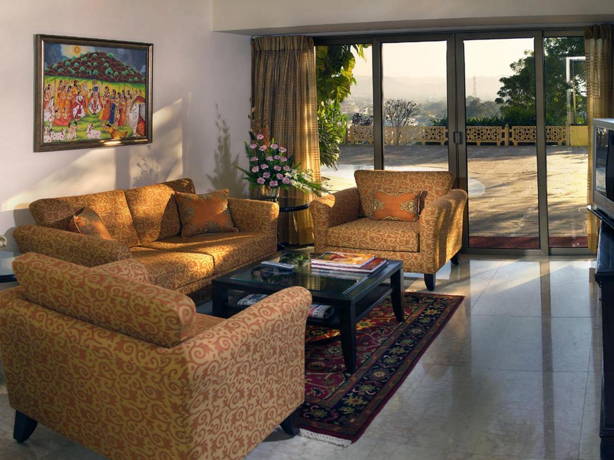 a living room with two couches and a coffee table at The Lalit Laxmi Vilas Palace in Udaipur