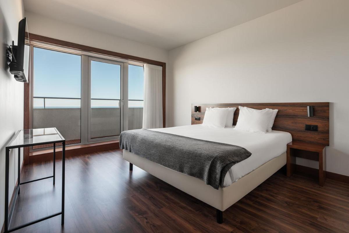 Uma cama ou camas num quarto em Dorma Praia Golfe