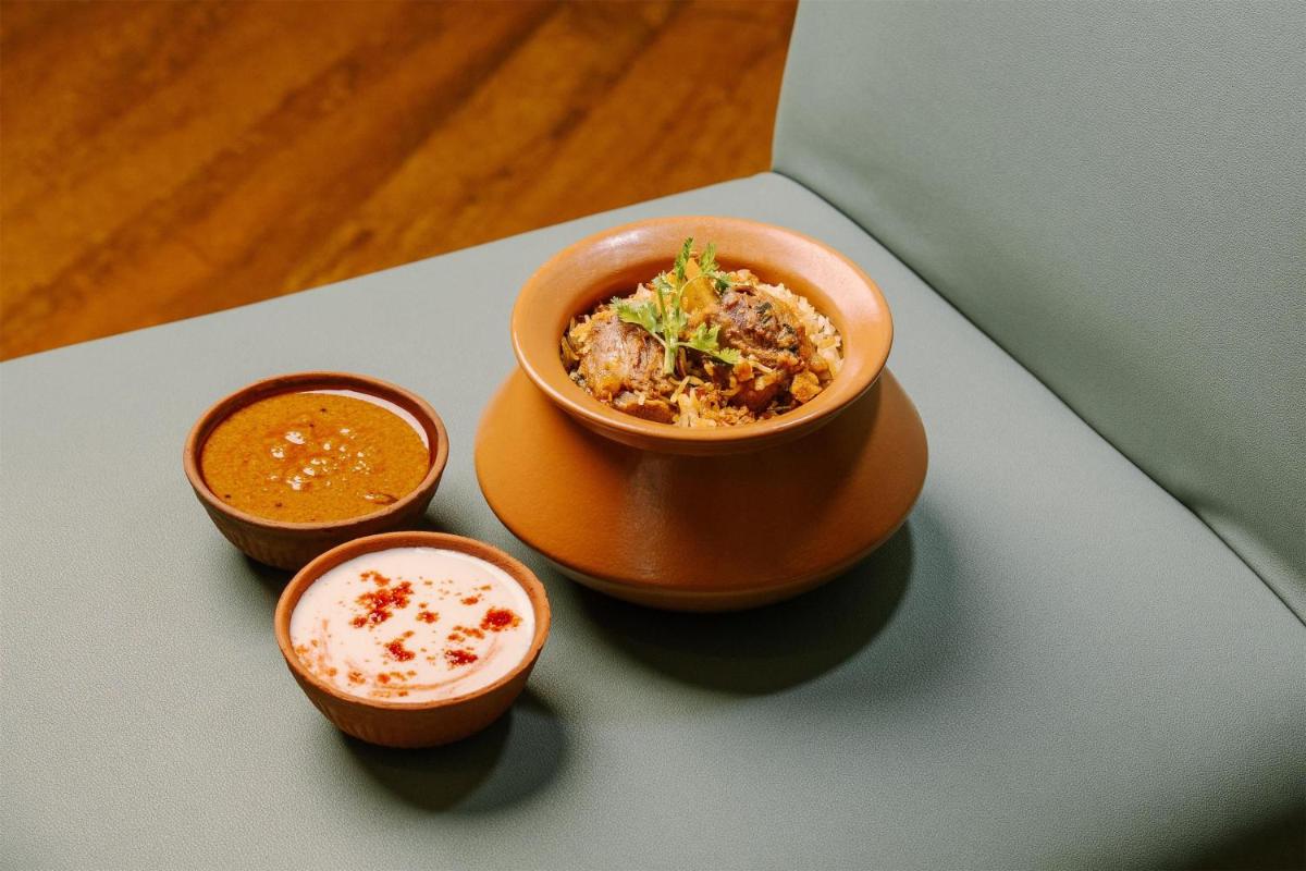 a bowl of food with three small bowls of sauce at Radisson Blu Plaza Hotel Hyderabad Banjara Hills in Hyderabad a bowl of food with three small bowls of sauce at Radisson Blu Plaza Hotel Hyderabad Banjara Hills in Hyderabad