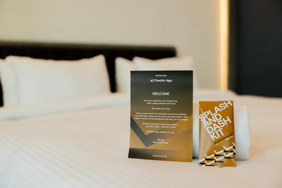 a brochure sitting on top of a bed at Sunday Hotel Chandigarh Zirakpur in Zirakpur