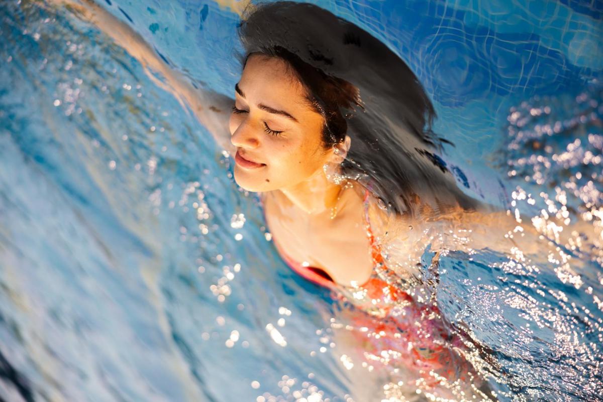 a woman in the water in a pool at Sunday Hotel Chandigarh Zirakpur in Zirakpur